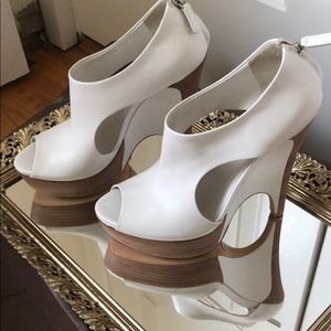 Gucci peep toe wedge booties with cutouts.